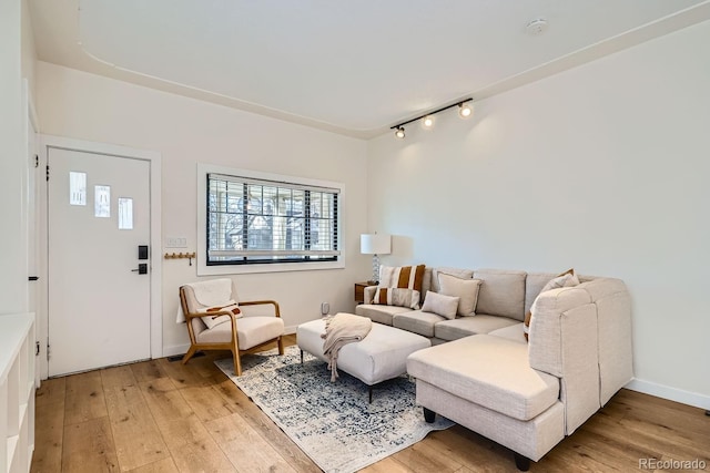 living area with baseboards and light wood-style floors