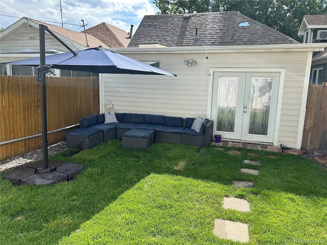 rear view of property with french doors, a yard, a shingled roof, an outdoor hangout area, and fence