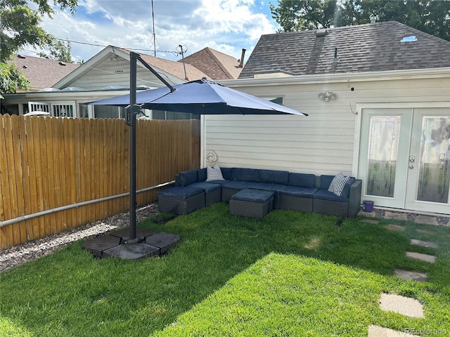 view of yard with french doors, outdoor lounge area, and fence