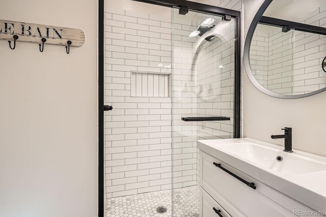 bathroom featuring a shower stall and vanity