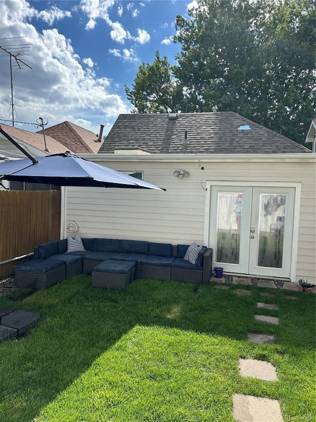 back of house with an outdoor hangout area, a yard, a shingled roof, and fence