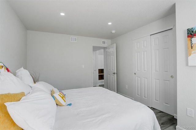 bedroom featuring dark hardwood / wood-style floors and a closet