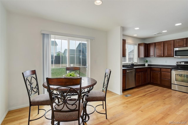 25812 E Cedar Pl, Aurora, CO 80018 - kitchen featuring appliances with stainless steel finishes, dark countertops, light wood-style flooring, a sink, and recessed lighting