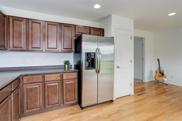 25812 E Cedar Pl, Aurora, CO 80018 - kitchen featuring stainless steel fridge, dark countertops, light wood finished floors, and recessed lighting