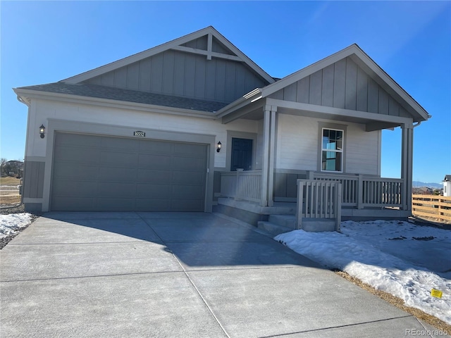 view of front facade with a garage and covered porch