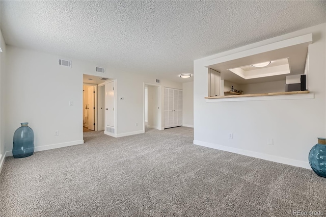 carpeted spare room featuring a textured ceiling