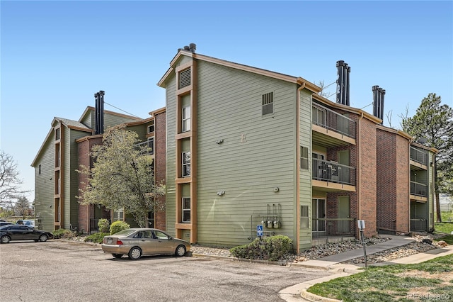 view of property featuring uncovered parking