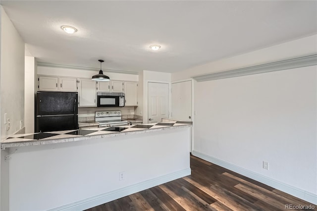 kitchen featuring a peninsula, baseboards, dark wood-type flooring, white cabinetry, and black appliances