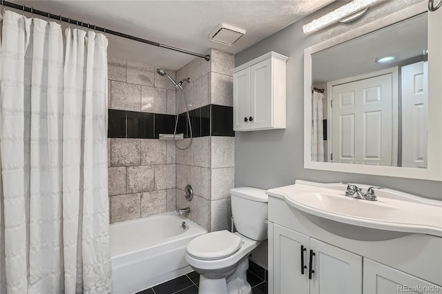 bathroom with vanity, toilet, tile patterned floors, a textured ceiling, and shower / bathtub combination with curtain