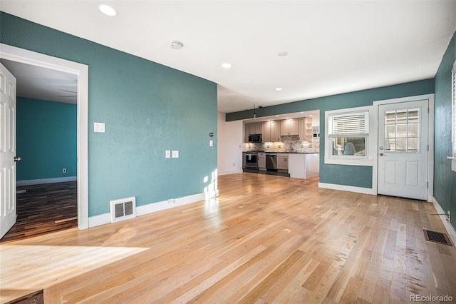 unfurnished living room featuring light wood-type flooring