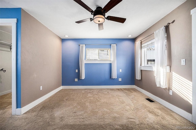 unfurnished bedroom featuring light carpet and ceiling fan