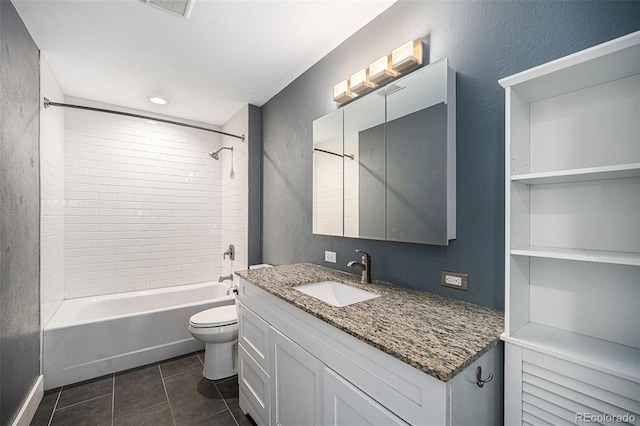 full bathroom with vanity, tiled shower / bath combo, tile patterned floors, and toilet