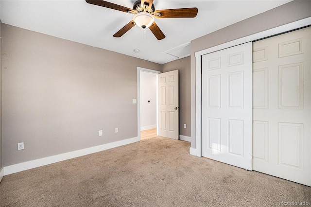 unfurnished bedroom with light colored carpet, ceiling fan, and a closet