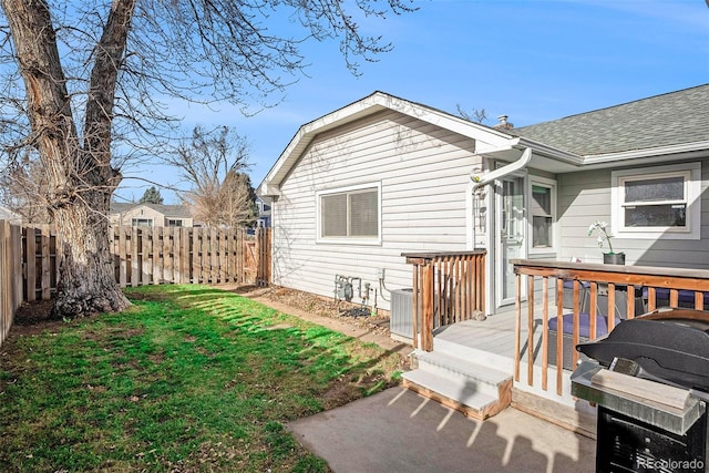 exterior space featuring a wooden deck and a yard