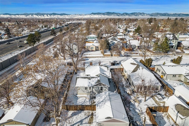 snowy aerial view with a mountain view