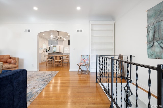 1661 Oneida St, Denver, CO 80220 - corridor with arched walkways, light wood finished floors, an upstairs landing, recessed lighting, and a chandelier