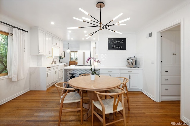1661 Oneida St, Denver, CO 80220 - dining area featuring recessed lighting, light wood-style floors, and a chandelier