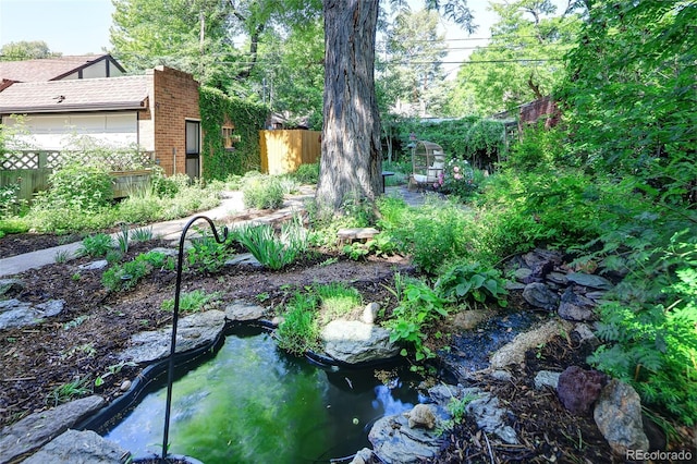 1661 Oneida St, Denver, CO 80220 - view of yard featuring a garden pond