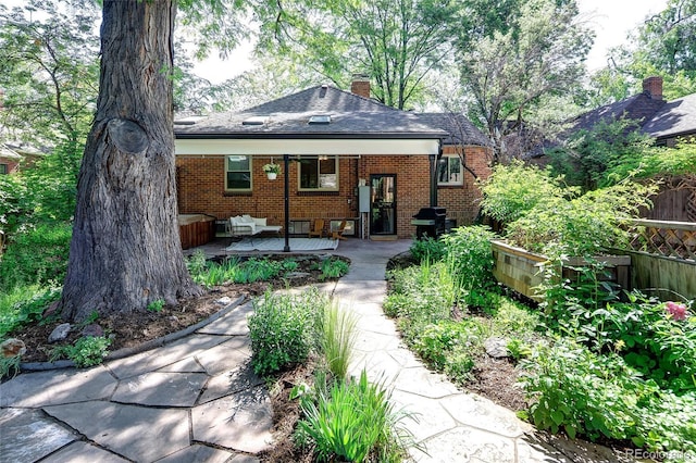 1661 Oneida St, Denver, CO 80220 - view of front of property with brick siding, a chimney, an outdoor hangout area, and a shingled roof