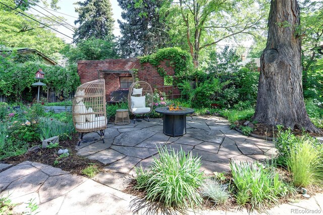 1661 Oneida St, Denver, CO 80220 - view of patio with an outdoor fire pit