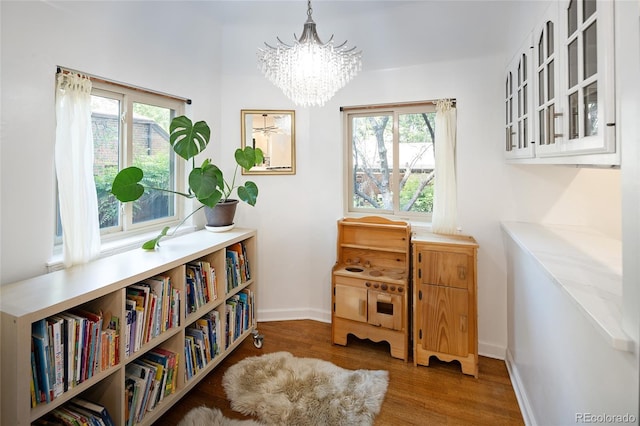 1661 Oneida St, Denver, CO 80220 - sitting room featuring wood finished floors, healthy amount of natural light, and a chandelier
