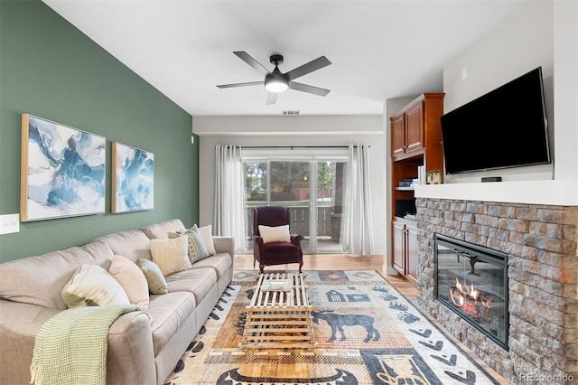 16600 Las Ramblas Ln Unit A, Parker, CO 80134 - living area featuring a brick fireplace, a ceiling fan, and light wood-type flooring