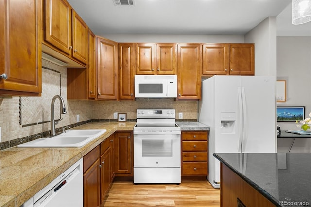 16600 Las Ramblas Ln Unit A, Parker, CO 80134 - kitchen featuring white appliances and brown cabinetry