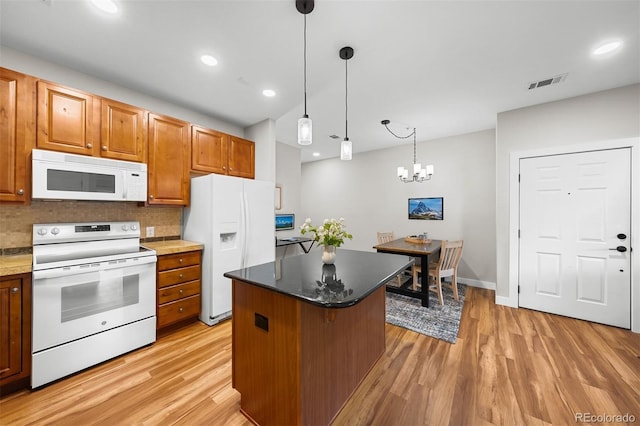 16600 Las Ramblas Ln Unit A, Parker, CO 80134 - kitchen with white appliances, light wood-style floors, a center island, tasteful backsplash, and recessed lighting