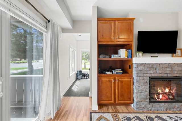 16600 Las Ramblas Ln Unit A, Parker, CO 80134 - living area featuring light wood-type flooring and a brick fireplace