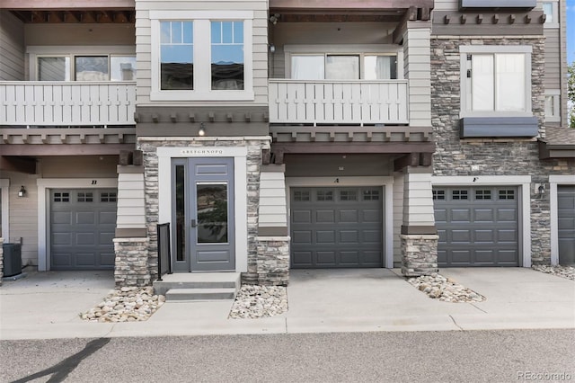 16600 Las Ramblas Ln Unit A, Parker, CO 80134 - view of front of property featuring a garage, a balcony, stone siding, and driveway