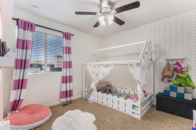 10796 Truckee Cir, Commerce City, CO 80022 - bedroom featuring baseboards, an accent wall, wallpapered walls, carpet floors, and ceiling fan