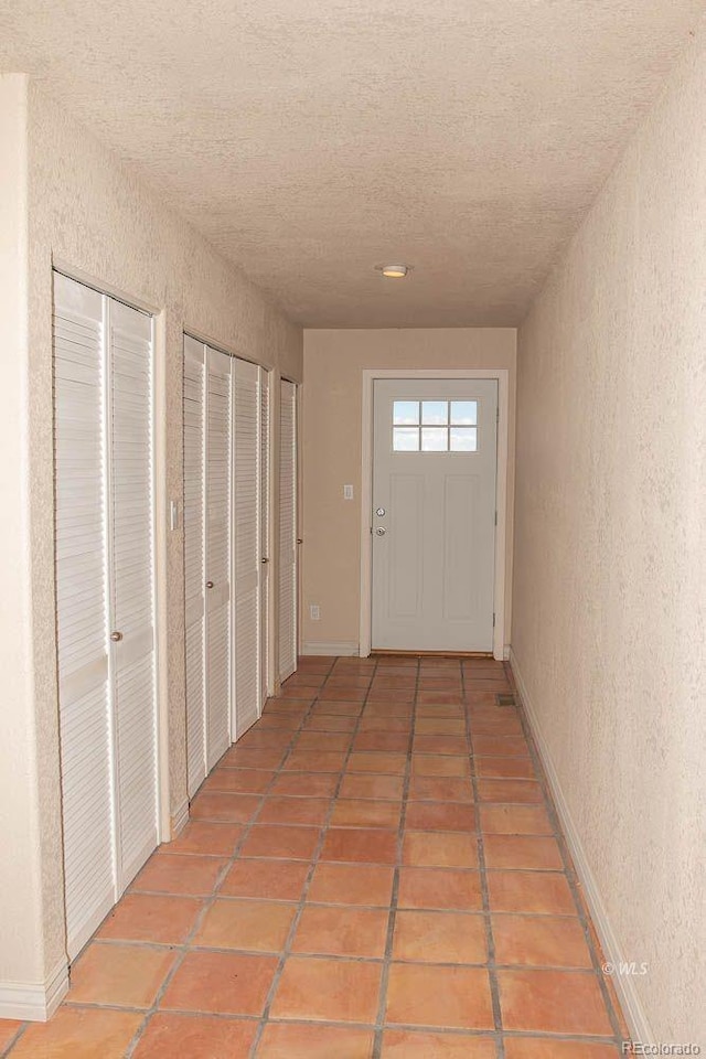 interior space with light tile flooring and a textured ceiling