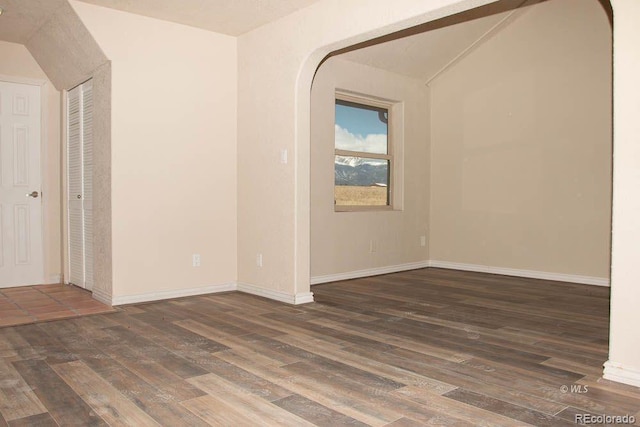 unfurnished room with dark hardwood / wood-style floors