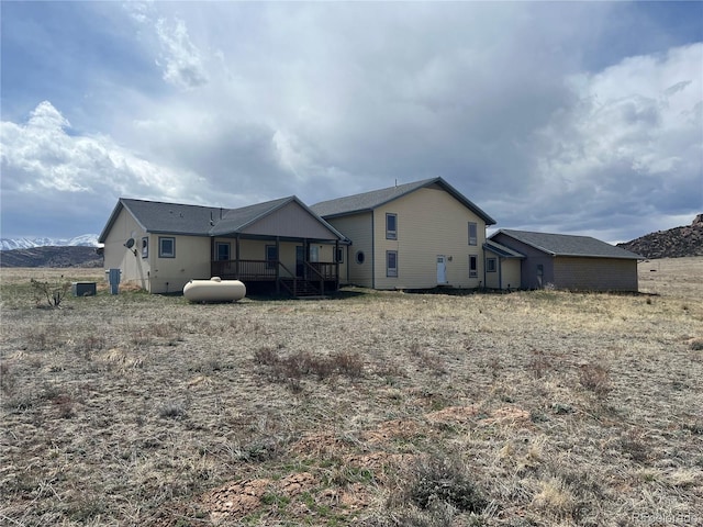 back of property featuring a wooden deck