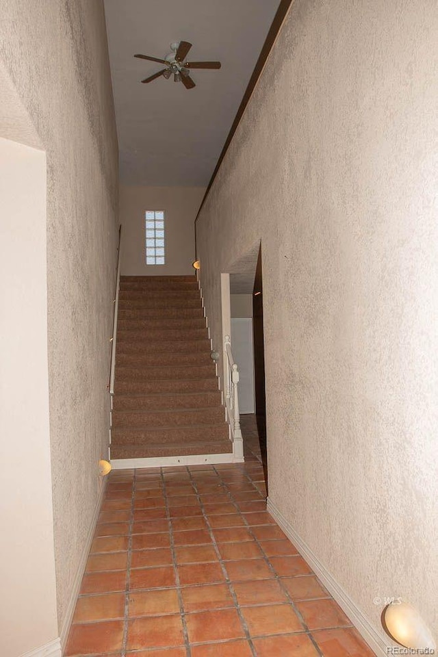 corridor featuring dark tile floors