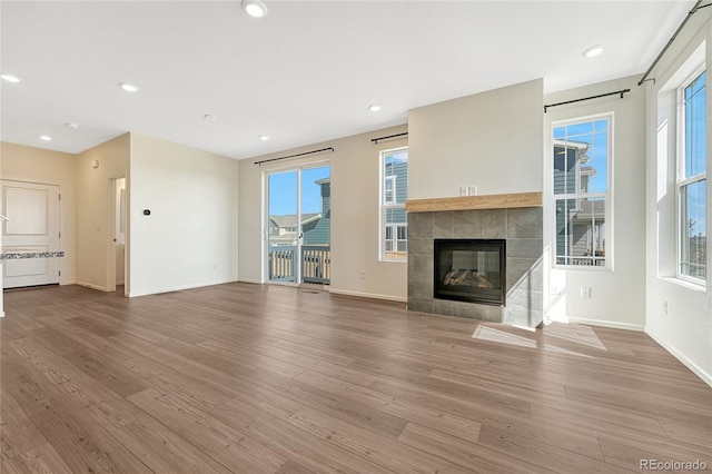 unfurnished living room featuring wood-type flooring and a fireplace