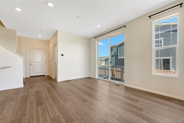 unfurnished living room featuring hardwood / wood-style flooring