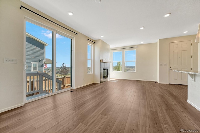 unfurnished living room with wood-type flooring