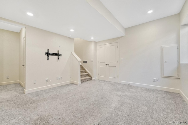 basement featuring light colored carpet