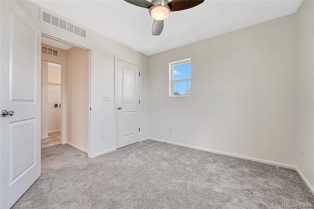 unfurnished bedroom featuring carpet, ceiling fan, and a closet