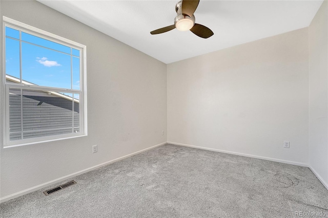 empty room with ceiling fan and carpet flooring