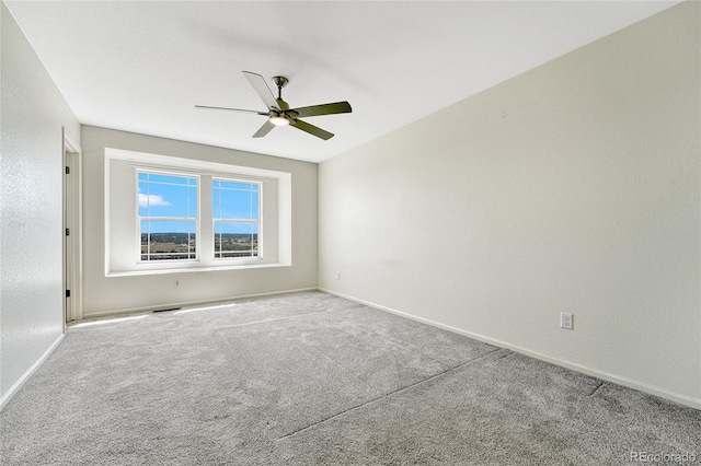 spare room with carpet and ceiling fan