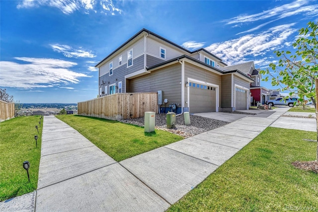 view of side of property with a garage and a yard