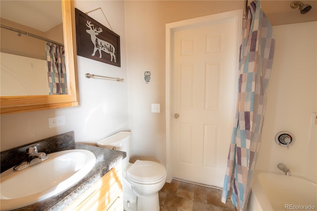 full bathroom with shower / bath combo, vanity, and toilet