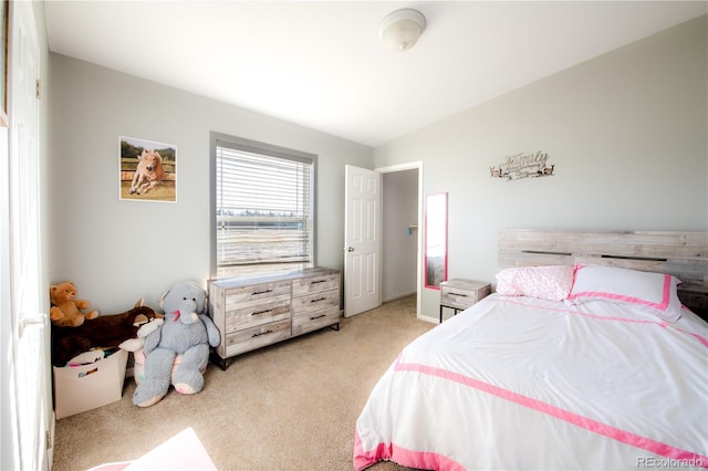 carpeted bedroom featuring lofted ceiling