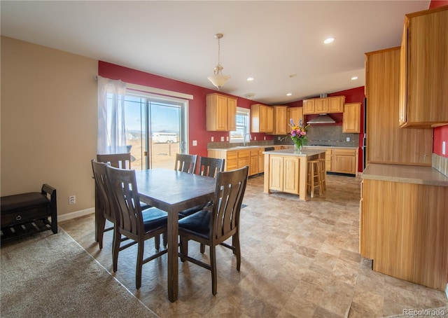 dining area featuring lofted ceiling and sink