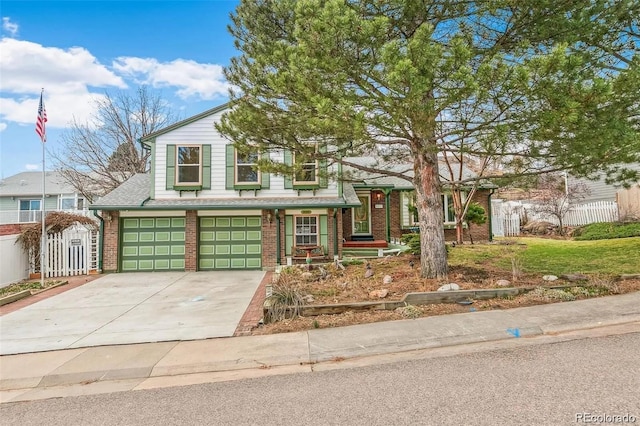 view of front of property featuring driveway, brick siding, an attached garage, and fence