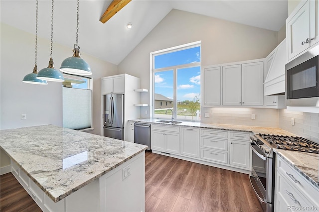 kitchen with decorative backsplash, appliances with stainless steel finishes, white cabinets, dark hardwood / wood-style floors, and hanging light fixtures