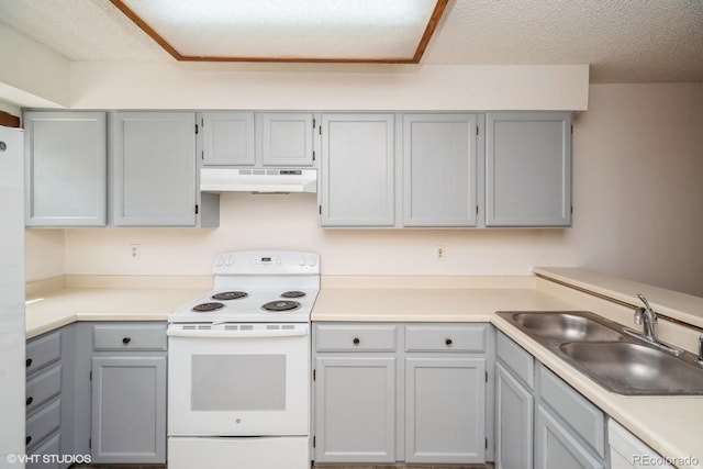 kitchen featuring a textured ceiling, gray cabinetry, white appliances, and sink