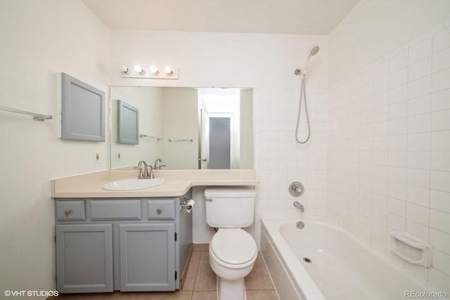 full bathroom featuring tile patterned flooring, vanity, tiled shower / bath combo, and toilet